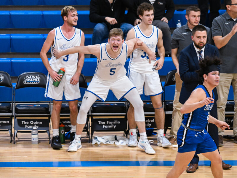 Giving 5 Monks men's basketball players cheer their fellow athletes during a game!