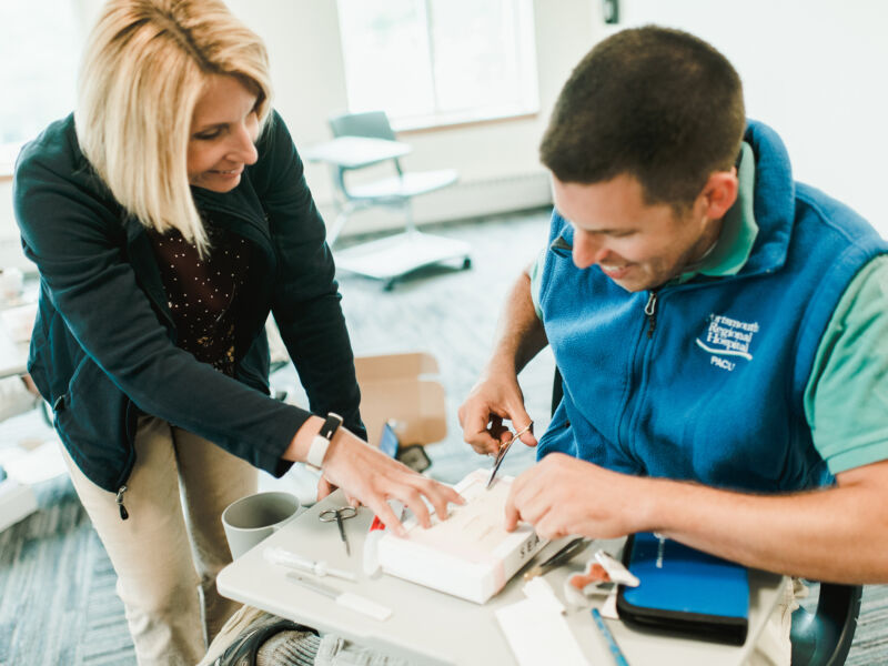 Giving 6 Nursing faculty works one-on-one with online nurse practitioner student honing their suturing skills.