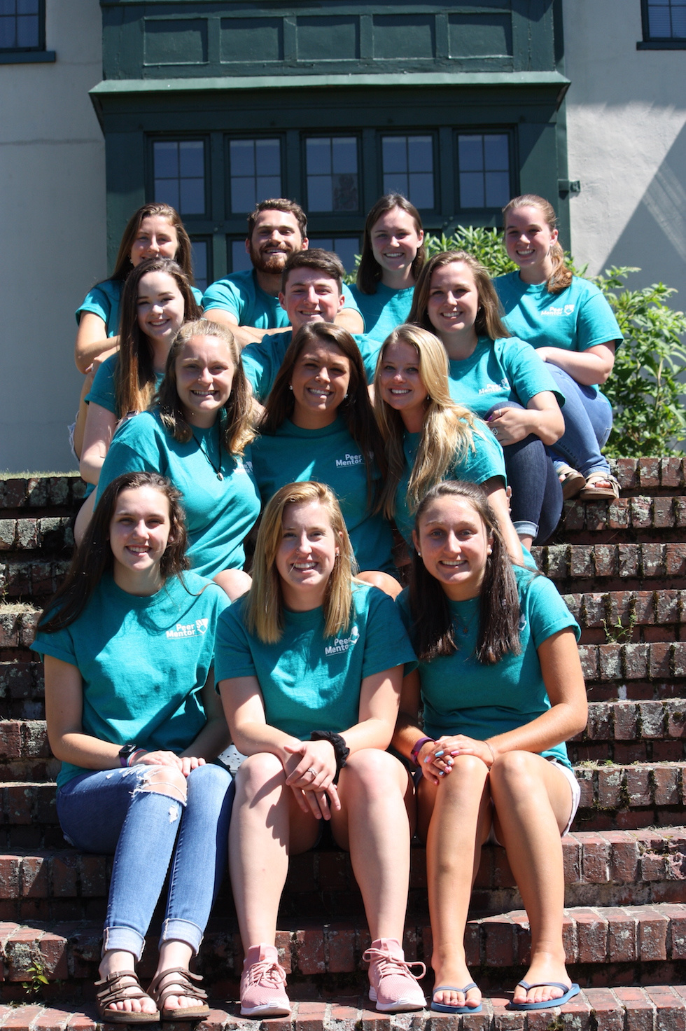 Peer Mentors pose on the steps of Xavier Hall