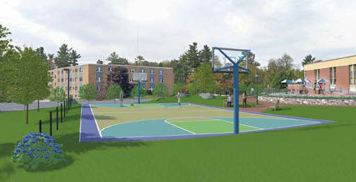 Outdoor basketball court with a blue and green surface, surrounded by grass and trees. An apartment building and another structure are visible in the background. This versatile area is perfect for fostering team success under Coach Putnam's guidance. Saint Joseph's College of Maine