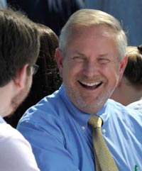 President Jim Dlugos engaged in conversation with a student at Convocation