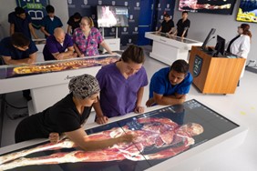 Saint Joseph’s College and Northeast College of Health Sciences Renew Articulation Agreement for Doctor of Chiropractic Program, Expand to Include Sciences Department 1 Medical students and instructors at Saint Joseph’s College study a 3D digital anatomy table displaying a human body model in a modern classroom equipped with multiple screens and lab equipment, part of the Sciences Department curriculum for the Doctor of Chiropractic Program. Saint Joseph's College of Maine
