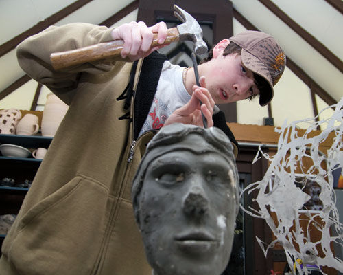 Fine arts student sculpting