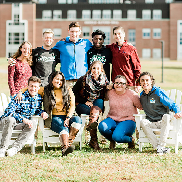 campus students in the fall gather in front of Alfond Hall