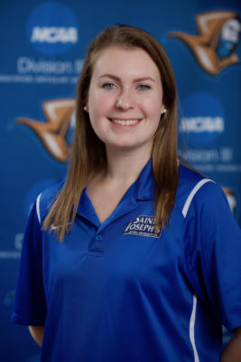 Newly hired Assistant Sports Information Director, Megan Dunlap, poses happily
