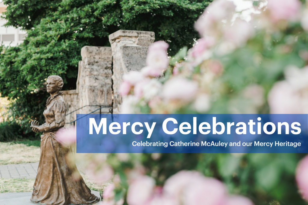 A bronze statue of a woman stands near stone monuments and blooming flowers. Text reads: Mercy Celebrations—Celebrating Catherine McAuley and our Mercy Heritage.. Saint Joseph's College of Maine