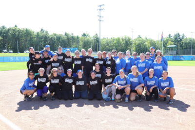 The alumni softball players gather for a group photo