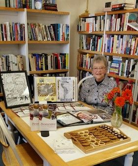 Barbara poses with her book at a signing in a bookstore.