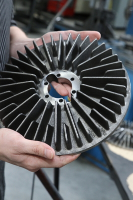 Hands holding a round disc with horizontal slots