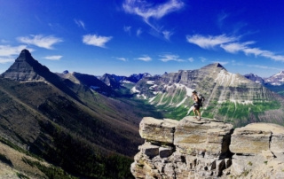 Effie stands on a mountaintop with a beautiful vista
