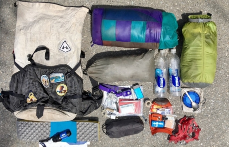Gear that Effie carried, including a tent, sleeping bag, water bottles, and bug spray.
