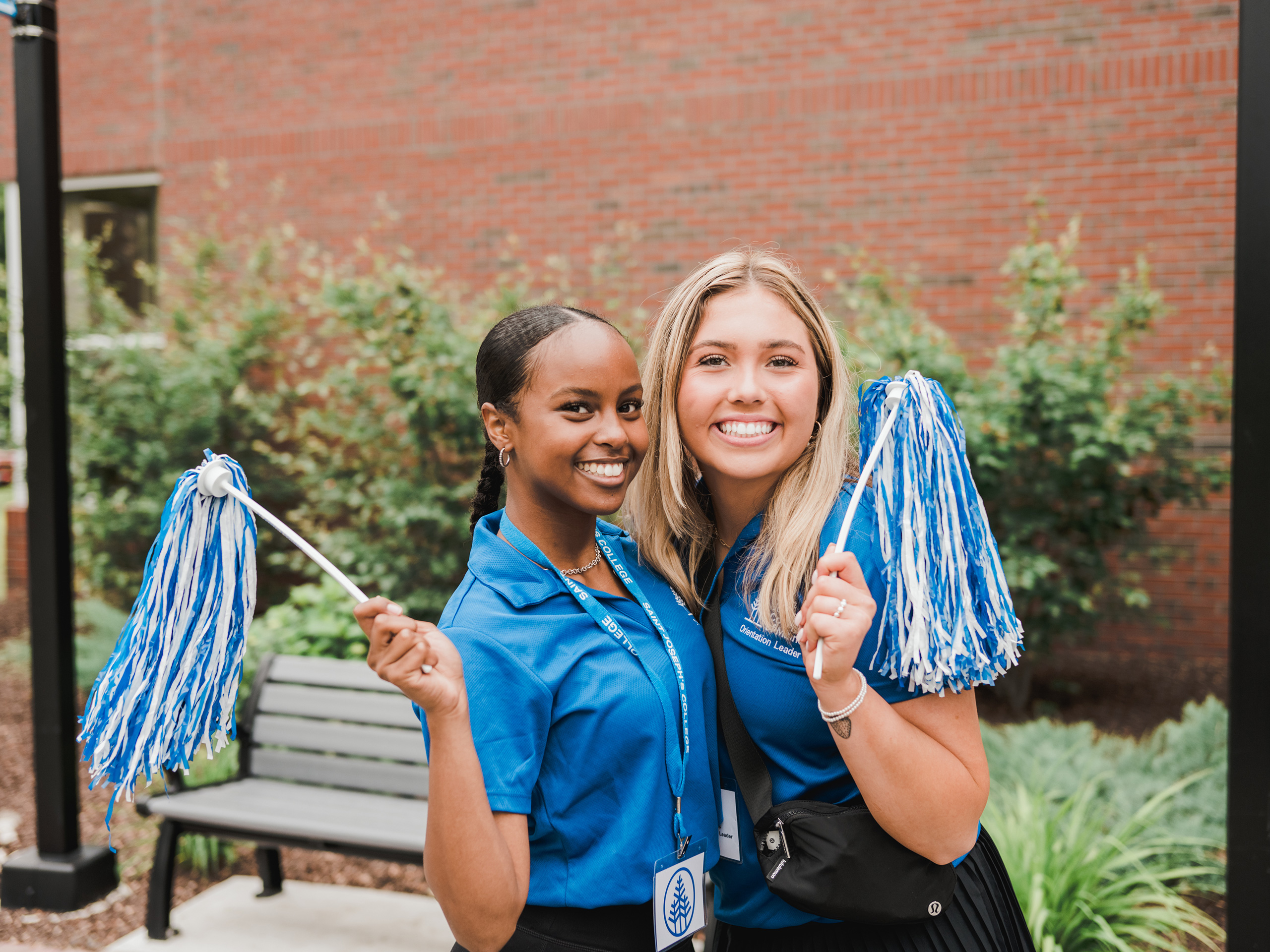 Female students welcoming new students to campus