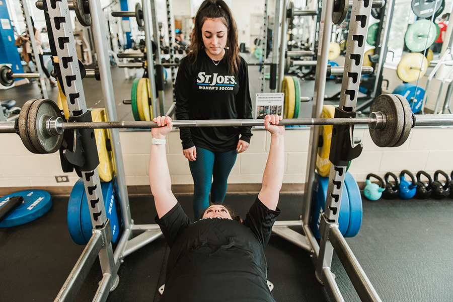 Exercise Science students work one-on-one with a fellow student, teaching them proper fitness skills.