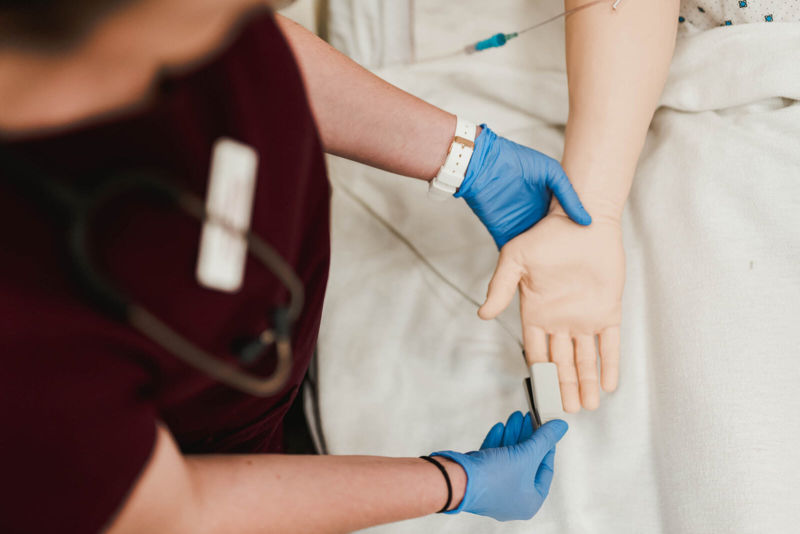 Nursing student practicing on simulation patient