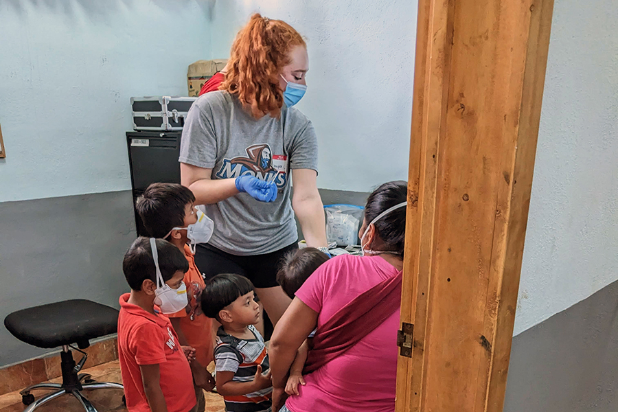 Service trip: Student testing for anemia in Guatemalan family