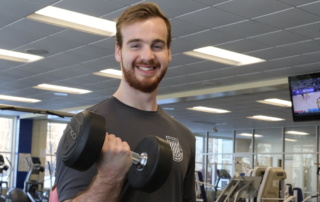 Tommy Dahlborg '18 lifts a weight in the fitness center.