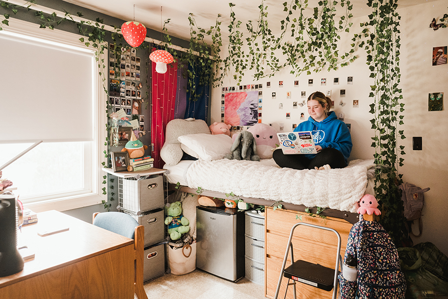 A female student studies in her dorm room.