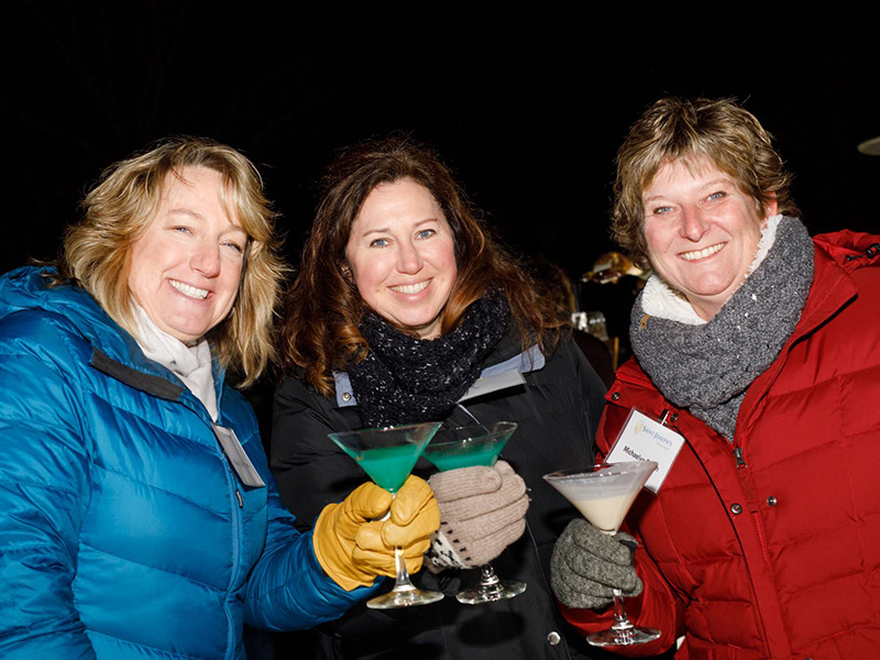 Three alumni enjoying the ice bar.