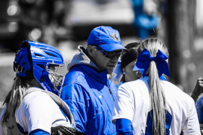 Smyth and members of the softball team huddle 