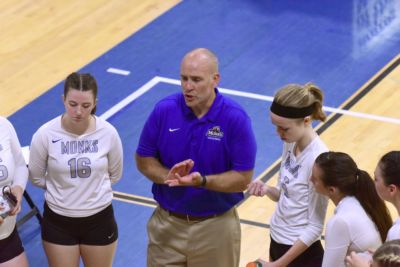 Coach Jon Roberts talks with his team during a break in the action