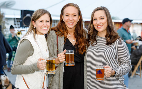 Group of female alums at the Monkstoberfest in 2018 at the Stone Barn at Saint Joseph's College of Maine