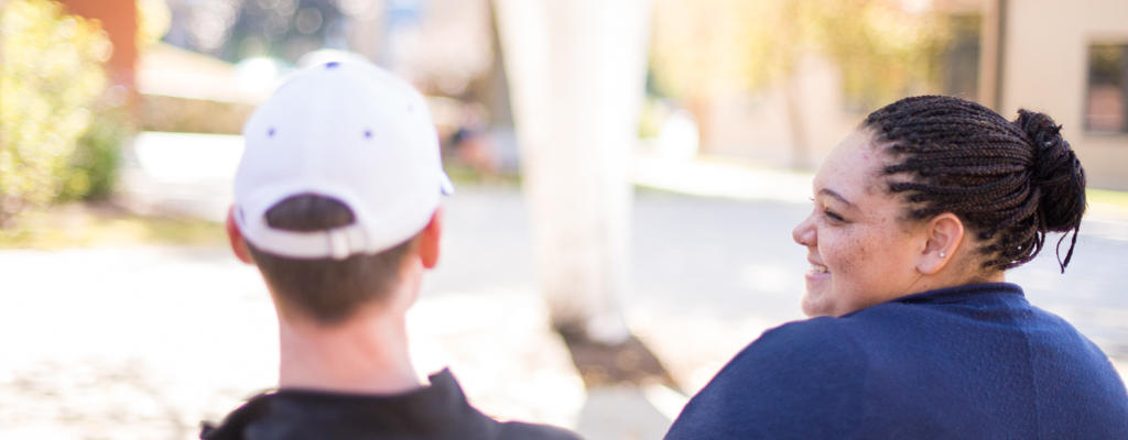 students on a bench talking to each other