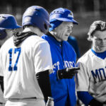 Sanborn talks to his team during a meeting on the pitcher's mound